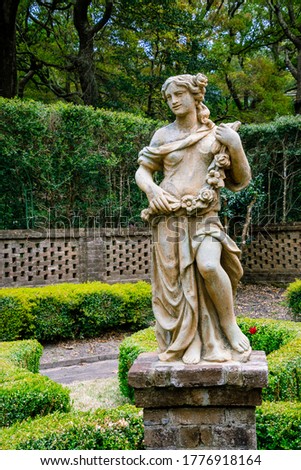 Full sized garden statue of a posed woman