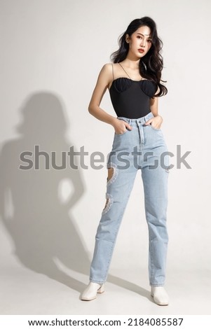 Full street fashion Slender figure, beautiful face, graceful woman standing on isolated white background. Portrait of female model in studio. plastic surgery and aesthetic cosmetology.