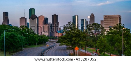 A full supermoon rising over Memorial Ave behind the Houston skyline in Houston, TX with all of the major Houston skyscrapers in view.