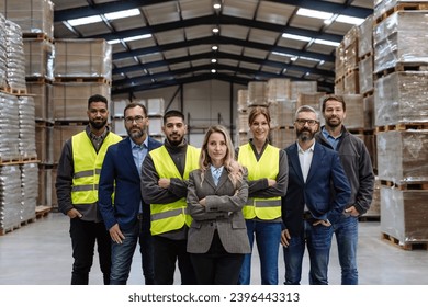 Full team of warehouse employees standing in warehouse. Team of workers, managers, female director in modern industrial factory, heavy industry, manufactrury. - Powered by Shutterstock