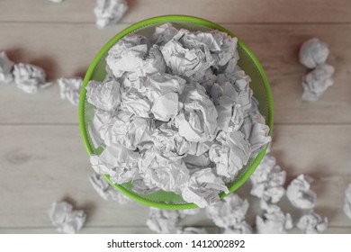 Full Trash Bin And Crumpled Paper On Floor, Top View