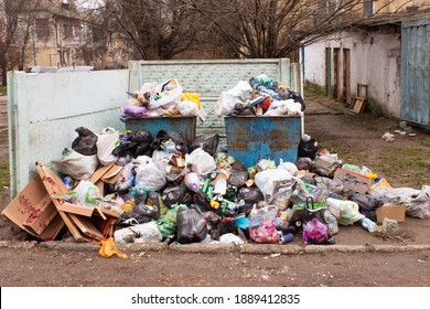 Full trash can. Trash can filled with trash. Trash can packed to overflowing with rubbish. The bin is filled with rubbish. - Shutterstock ID 1889412835