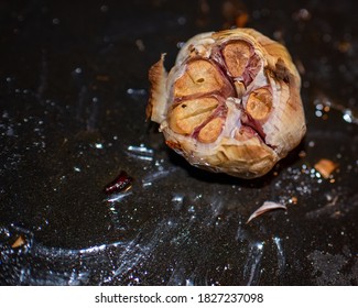 A Full Whole Roasted Garlic Clove Bulb On An Oven Tray