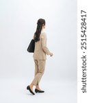 Full-body photo of a walking female business person from behind