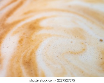Full-frame close-up texture surface of soft and delicate milk froth in a cup of coffee
