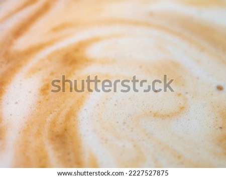 Full-frame close-up texture surface of soft and delicate milk froth in a cup of coffee