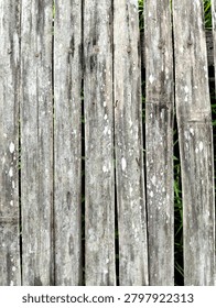 Full-frame top-down texture of weathered old bamboo slats with natural white mold spots and rusty iron nails. The aged rustic bamboo surface displays prominent vertical linear patterns, gray organic patina, and heavy environmental wear. High-resolution Asian ethnic abstract background ideal for vintage grunge overlays, traditional architectural mockups, and rustic texture design assets.