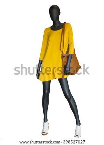 Full-length female mannequin dressed in yellow dress isolated on white background.