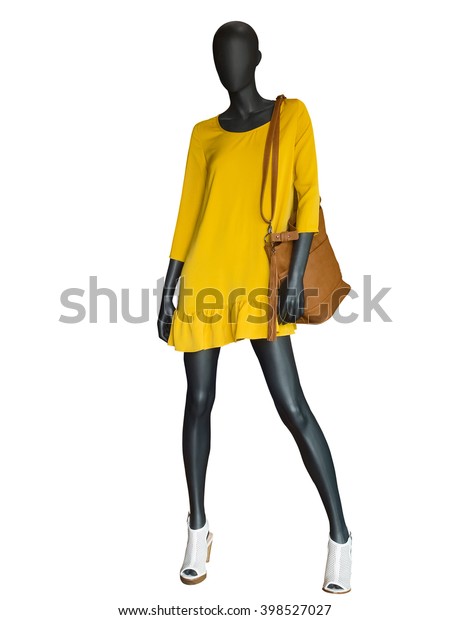 Full-length female mannequin dressed in\
yellow dress isolated on white\
background.