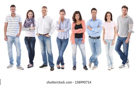 Full-length Group Portrait Of Happy Young Casual People Standing Side By Side, Looking At Camera, Smiling.