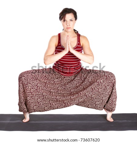 full-length portrait of beautiful woman working out yoga excercises on fitness mat