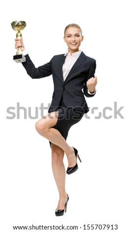 Full-length portrait of businesswoman keeping golden cup and fist up gesturing, isolated on white. Concept of victory and success