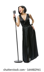 Full-length Portrait Of Woman Musician Wearing Long Black Evening Dress And Holding Mic