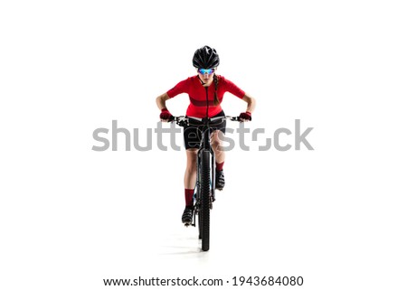 Full-length portrait of young woman, professional bicyclist with road bike, cycle isolated over white background.. Concept of sport, acton, motion, speed, race, healthy lifestyle. Copy space for ad.