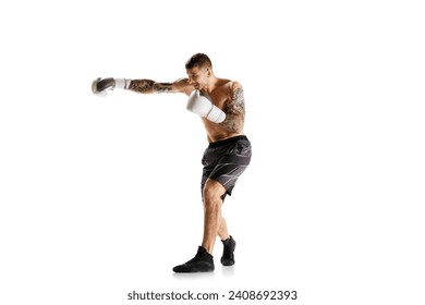 Full-length of shirtless young man with muscular strong body, boxer in motion, training isolated over white background. Concept of professional sport, combat sport, martial arts, strength - Powered by Shutterstock