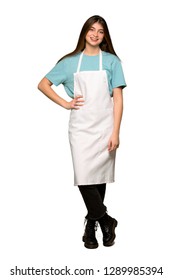 Full-length Shot Of Girl With Apron Posing With Arms At Hip And Smiling On Isolated White Background