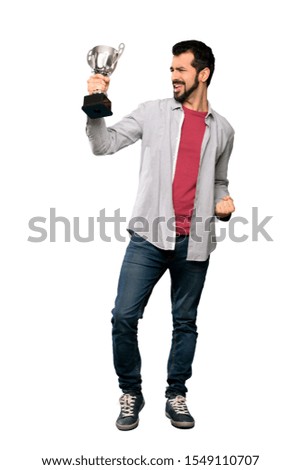 Full-length shot of Handsome man with beard holding a trophy over isolated white background
