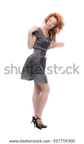 Fulllength shot of a redhead in a grey dress
