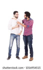 A Full-length Shot Of Two Friends Standing Talking And Joking Together, Smiling, Isolated On A White Background.