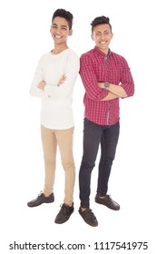 Full-length shot of two friends standing back to back crossed arms smiling, isolated on a white background.