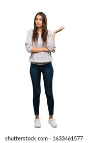 A Full-length Shot Of A Young Hispanic Brunette Woman Unhappy For Not Understand Something Over Isolated White Background