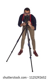 full-length shot of a young photographer wearing a classic outfit, putting his camera on the stand to preparing to start working, isolated on white background