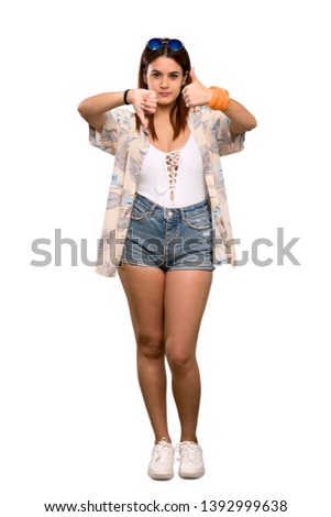 Full-length shot of Young woman in bikini in summer holidays making good-bad sign. Undecided between yes or not over isolated white background
