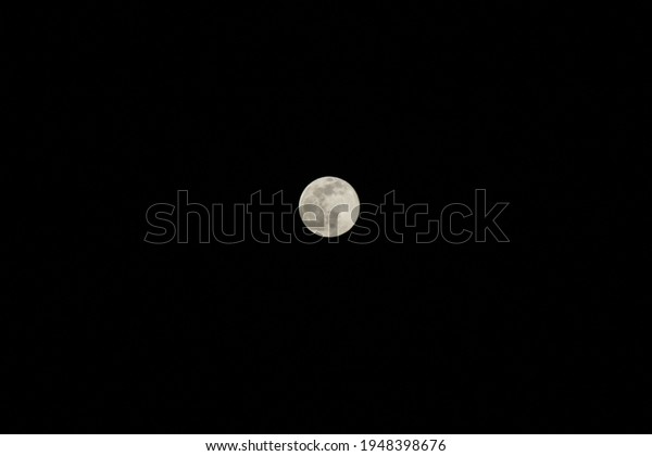 Fullmoon lunar phase in\
dark night sky