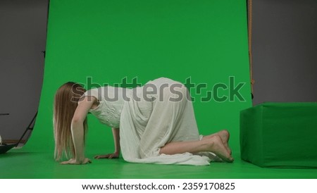 Full-size side view green screen chroma key shot of a posessed female, woman figure, ghost, poltergeist, zombie crawling out of the frame. The ring reference. Chroma key.