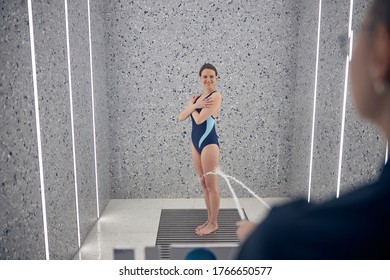 Full-sized Portrait Of A Female Patient With Her Arms Crossed Standing During The Hydrotherapy Procedure