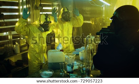 Fully Armed Special Anti-Narcotics Task Forces Soldier Arrests Two Clandestine Chemists Working in the Illegal Drug Producing Underground Laboratory. A lot of Drug Production Equipment is Lying around