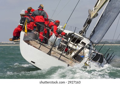 A Fully Crewed Racing Yacht Racing Hard And Leaving A Big Wake