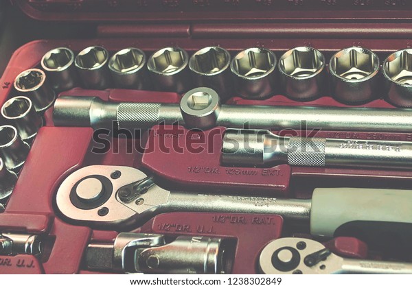 Fully Equiped Tool Kit.\
Instrument. Auto parts equipment in red box tool. ratchet kit on\
red background