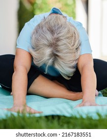 Fully Grey But Still Flexible. Shot Of A Senior Woman Doing Yoga Outside In Her Yard.