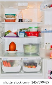 A Fully Stocked Refrigerator With Leftovers And Fruits And Veggies. 