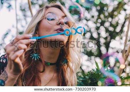 Fun Blonde Blowing Bubbles at a Festival