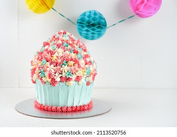 Fun Cake Giant Cupcake For Celebration Birthday Party White Background With Copy Space. Selective Focus.