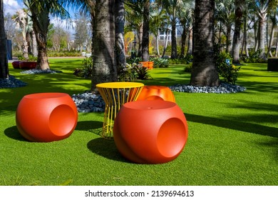 Fun colorful plastic chairs and table in a tropical park
