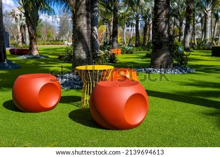 Fun colorful plastic chairs and table in a tropical park
