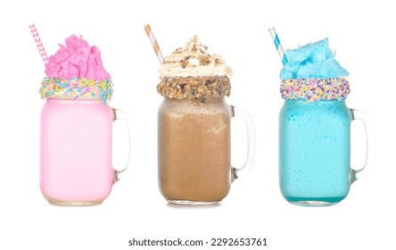 Fun colorful summer milkshakes in mason jar glasses isolated on a white background. Pink and blue cotton candy and chocolate sweet drinks.