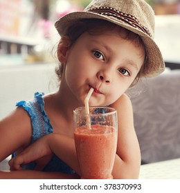 Fun Cute Kid Girl Drinking Healthy Smoothie Juice In Street Restaurant. Closeup Toned Portrait