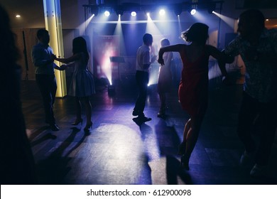 Fun Dance Party At Nightclub After Wedding Reception, Guests And Friends Dancing On The Floor Night With Lights, Disco Concept