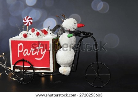 A fun decoration featuring a small decorative snowman pulling a full truckload of friends to a holiday party on his bicycle. Possible concept: party invitation, postcard.