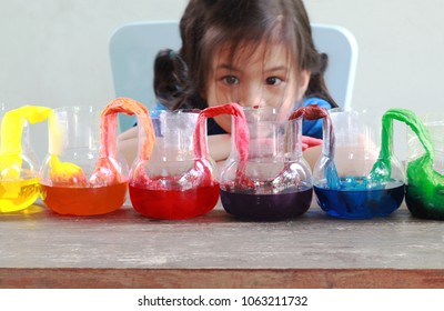 Fun And Easy Science.5 Years Old Asian Girl Making Walking Water Experiment.Food Color Add To The Water In The Recycled Bottle,water Moving Along The Paper Then Color Mixed.Concept Of Science For Kid 