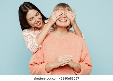 Fun elder parent mom with young adult daughter two women together wear casual clothes close eyes with hands play guess who or hide and seek isolated on plain blue cyan background. Family day concept - Powered by Shutterstock