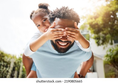 Fun Father Playing With His Young Daughter On His Back In Their Family Home Garden Bonding Together. Small Child Laughing And Enjoying Happy, Silly Childhood Lifestyle With Loving Parent