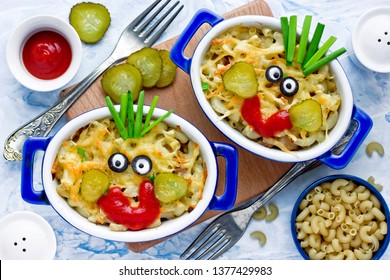 Fun Food Idea For Kids - American Mac And Cheese Macaroni Pasta Baked With Cheesy Sauce Decorated With Vegetables Like A Smiling Funny Face