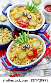 Fun Food Idea For Kids - American Mac And Cheese Macaroni Pasta Baked With Cheesy Sauce Decorated With Vegetables Like A Smiling Funny Face