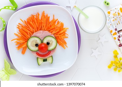 Fun Food For Kids - Cute Smiling Clown Face On Ham Sandwich Decorated With Fresh Cucumber, Carrots And Tomatoes For A Healthy Lunch For Children. Creative Cooking Idea