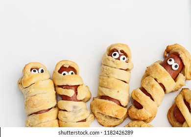 Fun food for kids. Halloween mummy hot dogs.  Wieners wrapped in croissant rolls to look like mummies on a plate. Alternative to candy.